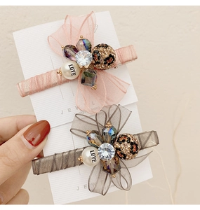 Detail of pink and grey organza bow clips with rhinestones and LOVE pearl bead