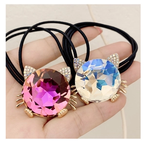 Macro detail of cute cat crystal hair ties with sparkling rhinestones and black elastic bands