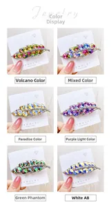 Detail view of leaf-shaped hair clips featuring vibrant rhinestones and golden alloy