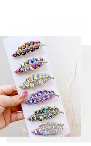 Detail view of leaf-shaped rhinestone duckbill clips with crystal inlay on alloy base