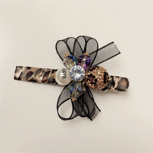 Leopard print duckbill clip with black organza bow and sparkling rhinestone accents