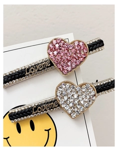 Detailed close-up of heart hair clips with pink and white rhinestones and Loveme letters