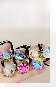 Macro view of crystal cat-shaped hair ties with rhinestones and black elastic bands