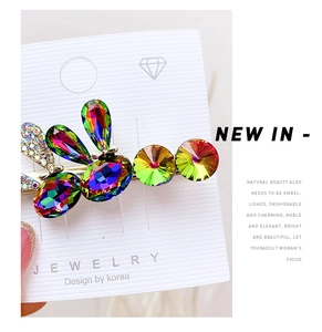 Macro shot of colorful pear-cut rhinestones on a stylish Korean duckbill hair clip