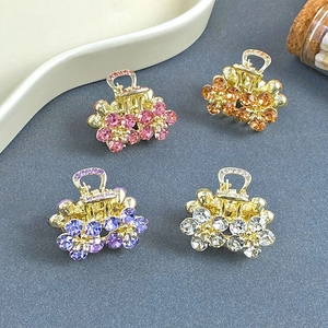 Set of four mini crystal flower hair claws in pink, orange, purple and silver tones