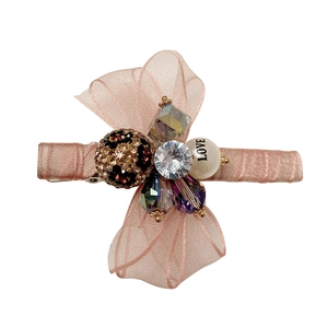 Pink organza bow hair clip with rhinestones and leopard print bead on white background