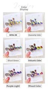 Detail showing various colors of rhinestone leaf hair clips in hand-held macro views