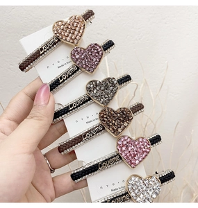 Detailed set of six woven heart hair clips with rhinestones and Loveme lettering