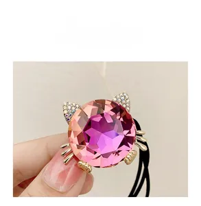 Macro view of cute cat hair tie featuring pink crystal and sparkling rhinestones