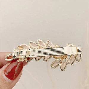 Golden spring hair clip with pink crystal wheat ear design shown from back view