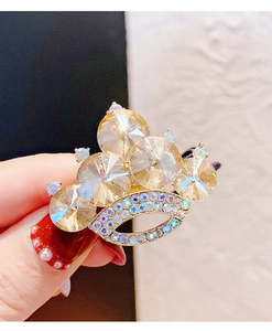 Dettaglio macro dell'elastico a corona con cristalli champagne e strass colorati