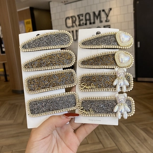 Elegant pearl and rhinestone BB hair clips set with heart and bear charms on display card