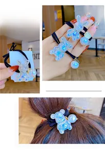 Detail showing colorful bear and rabbit hair ties with pearls and sparkly rhinestones