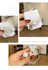 Detailed macro view of pearlescent bear hair ties with elastic beige cord and pearls