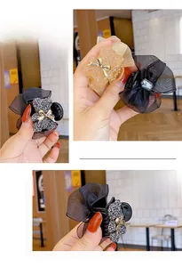 Detail of bear hair claw clip with rhinestones and organza bow for women