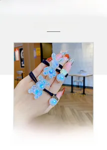 Detail of pearlescent bear and rabbit hair ties with elastic bands and pearl charms