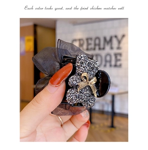 Detail of Korean style hair claw with organza bow and sparkling rhinestone bear