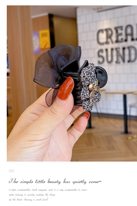 Detail of Korean style hair claw clip featuring black organza bow and sparkling rhinestones