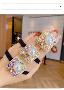 Detail showing elastic hair ties with bee embossment and colorful crystals on wrist