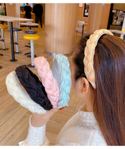 Macro shot of wide braided organza headbands in beige, black, pink, blue and gold colors