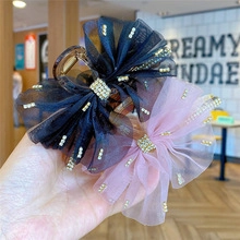 Detail of mesh bow hair clips with pearls and rhinestones in navy and pink