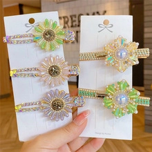 Detailed set of five floral hair clips with pearls and crystals on golden metal base