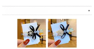 Detailed close-up of camellia pearl bow hair clip with rhinestone and golden alloy base