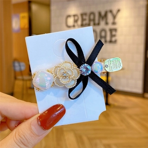 Elegant camellia hair clip with pearl bow and rhinestone detail for women