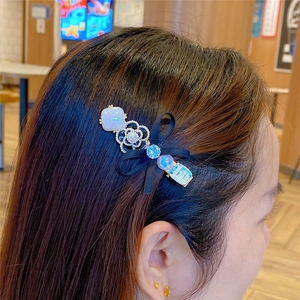 Elegant camellia hair clip with pearls, black bow, and blue rhinestones for women