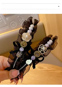 Close-up of vintage pearl camellia headbands with lace and sparkling rhinestones