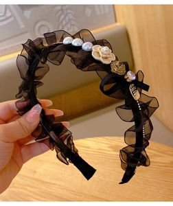 Detail of vintage organza headband with pearls, rhinestones and camellia flower