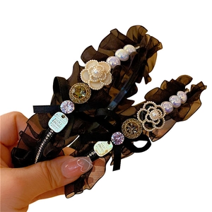 Elegant black lace headband with pearls, rhinestones, and camellia floral details