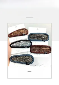 Macro detail of rhinestone BB hair clips with leather weave edges in multiple colors