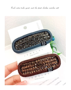 Close-up of hand-made woven hair clips with sparkling crystals in grey blue and brown