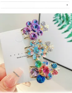 Detailed close-up of three colorful crystal grape hair clips with gold alloy bases