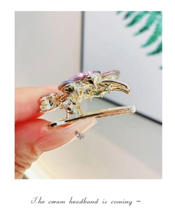Detail of Korean style purple crystal hair clip with gold metal base and rhinestones