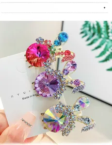 Detailed view of three luxury rhinestone hair clips in purple and rose red crystals