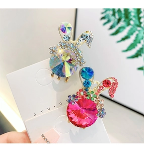Detailed close-up of rabbit hair clips with vibrant crystals and sparkling rhinestones