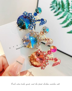 Close-up of rabbit-shaped crystal hair claws in blue, champagne, and pink crystal stones