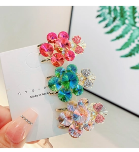 Detailed macro view of crystal flower hair clips with rhinestones on display card