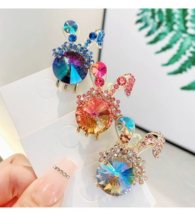 Close-up of rabbit hair clips with sparkling rhinestones in pink, blue and champagne colors