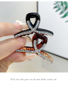 Detail of amber and black shark hair clips with sparkling rhinestone triangle accents