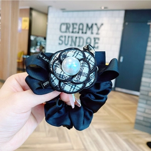 Elegant black satin scrunchie with camellia flower, houndstooth patterns and pearl accent