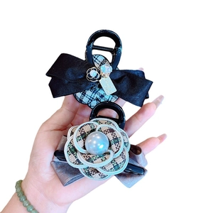 Elegant camellia flower and pearl hair claw clip set with classic black ribbon and patterns