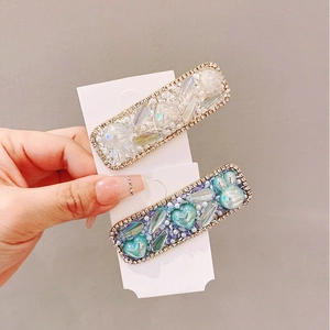 Detailed macro of crystal heart and rabbit barrettes with pearls and rhinestones