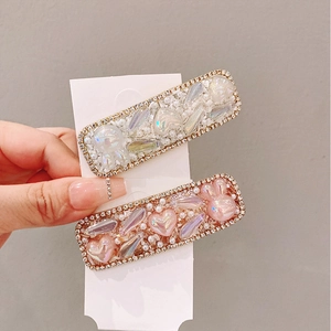 Detail of pink and white heart hair clips with rhinestones and faux pearls