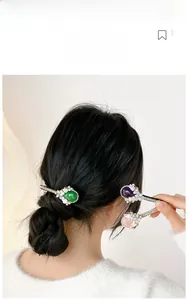 Detailed shot of emerald and opal hair clips set with pearls and floral crystal accents