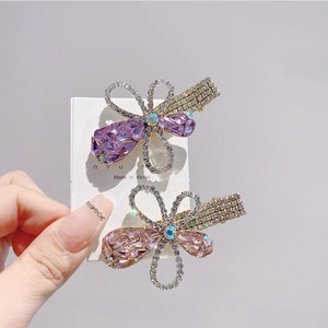 Sparkling butterfly hair clips set with purple and pink crystals on metal duckbill grips