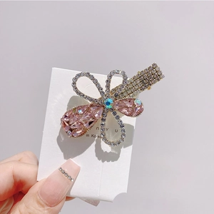 Detail showing handcrafted pink crystal flower hair clip with sparkling rhinestones