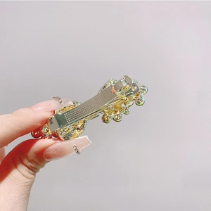 Detail of Korean-style gold alloy hairpin with colorful rhinestones and beads